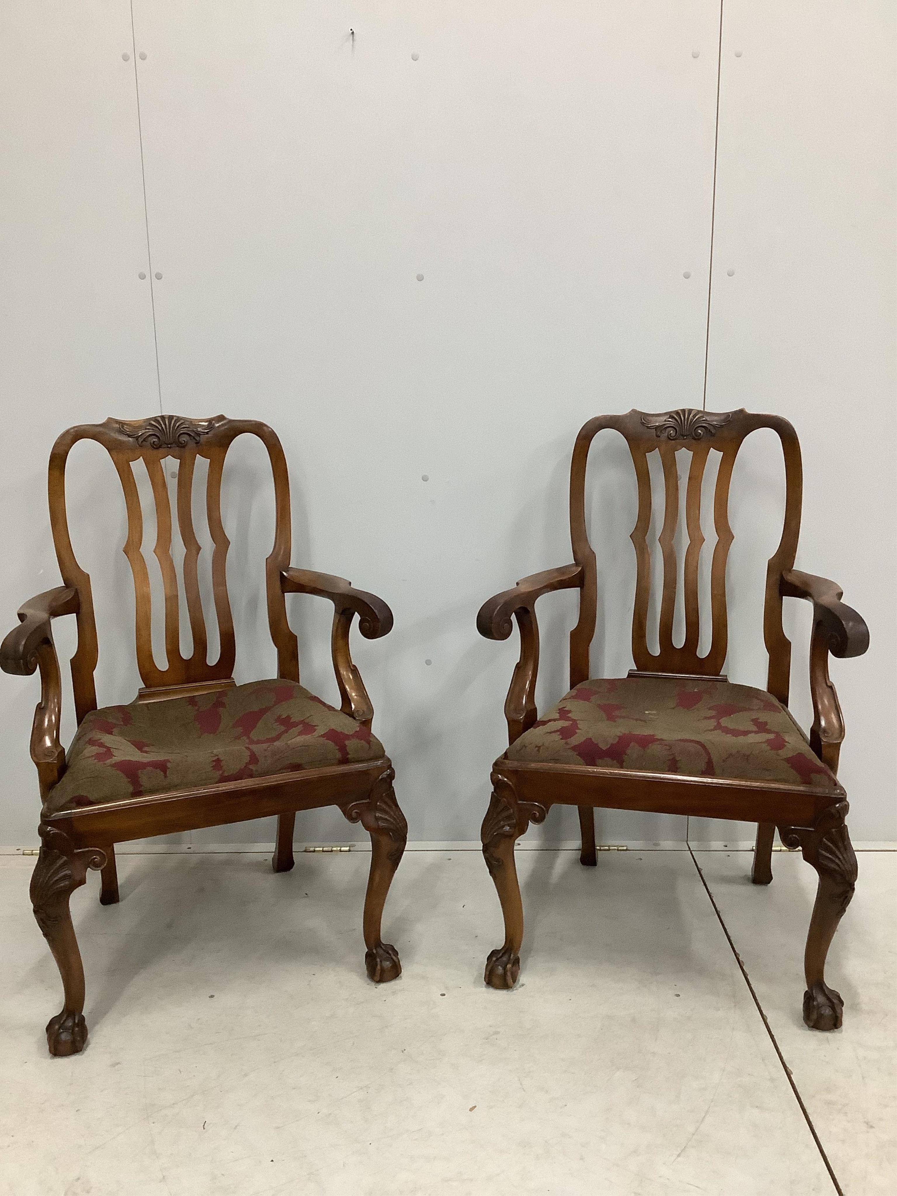 A set of eight George II style mahogany dining chairs on cabriole legs and ball and claw feet, two with arms. Condition - fair